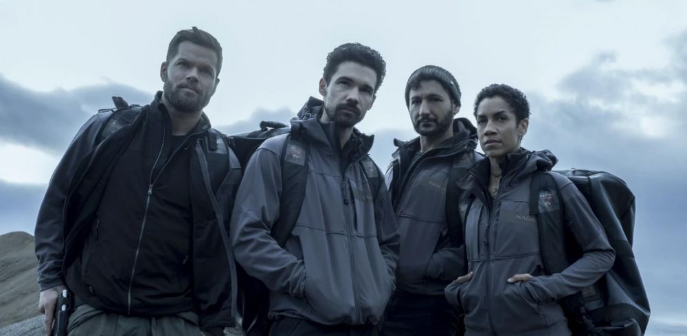 Amos, Holden, Alex, and Naomi from the Expanse, standing on Ilus.