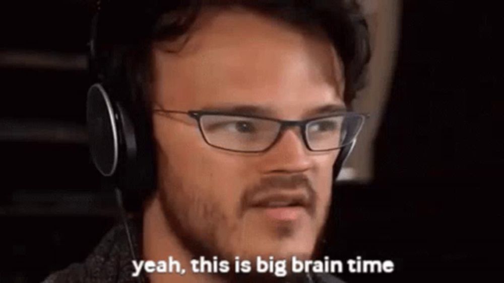 a man with glasses and headphones is saying `` yeah , this is big brain time '' .