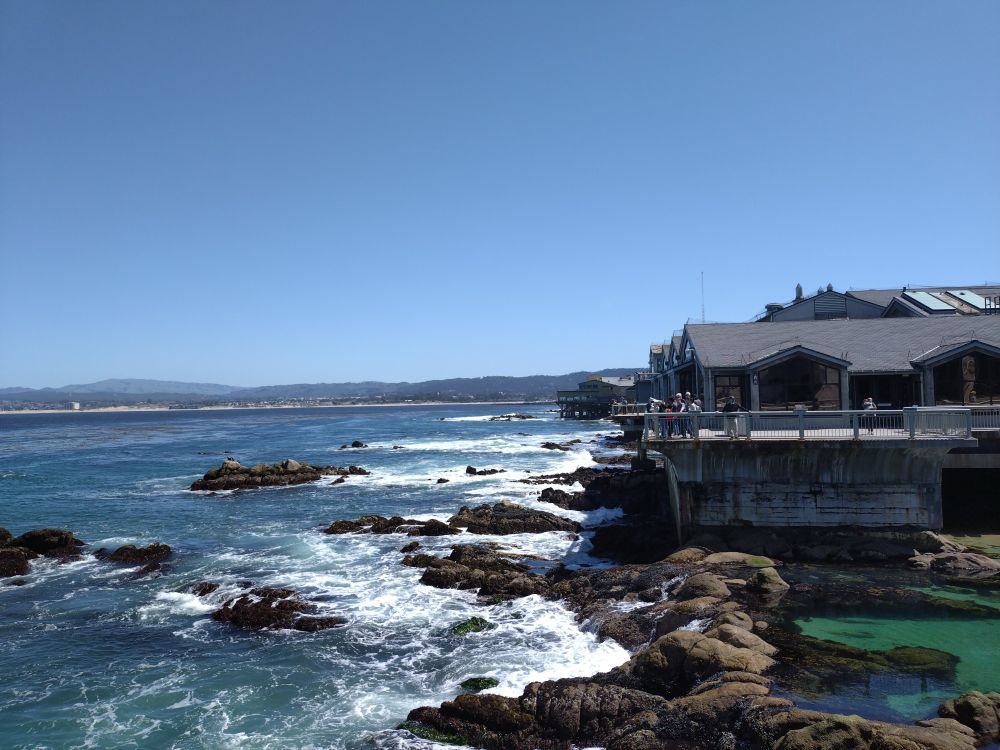 Waves crashing onto the rocky shore outside of the aquarium