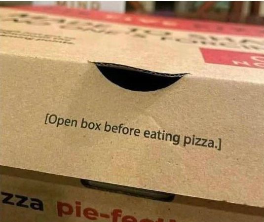 A pizza box with “Open box before eating pizza.” written on it.