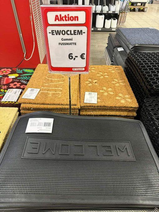 A “welcome” doormat upside down.
The sign says “EWOCLEM doormat” 6€