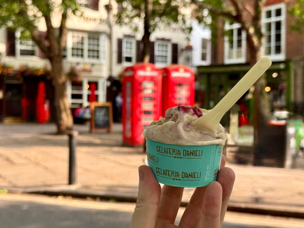 A cup of ice cream. Red cabins and a pub (the prince's head in Richmond) in the background.