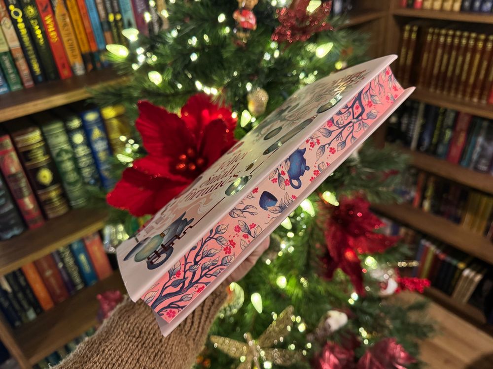 Spray edge of the book with branches and teapots