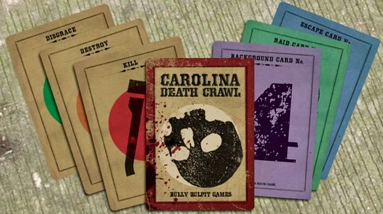 Card spread from Carolina Death Crawl RPG from Bully Pulpit Games, as IDed in the top card with an upside down skull. Cards at left labeled Kill, Destroy, Disgrace. Cards at right labeled Background Card, Raid Card, Escape Card