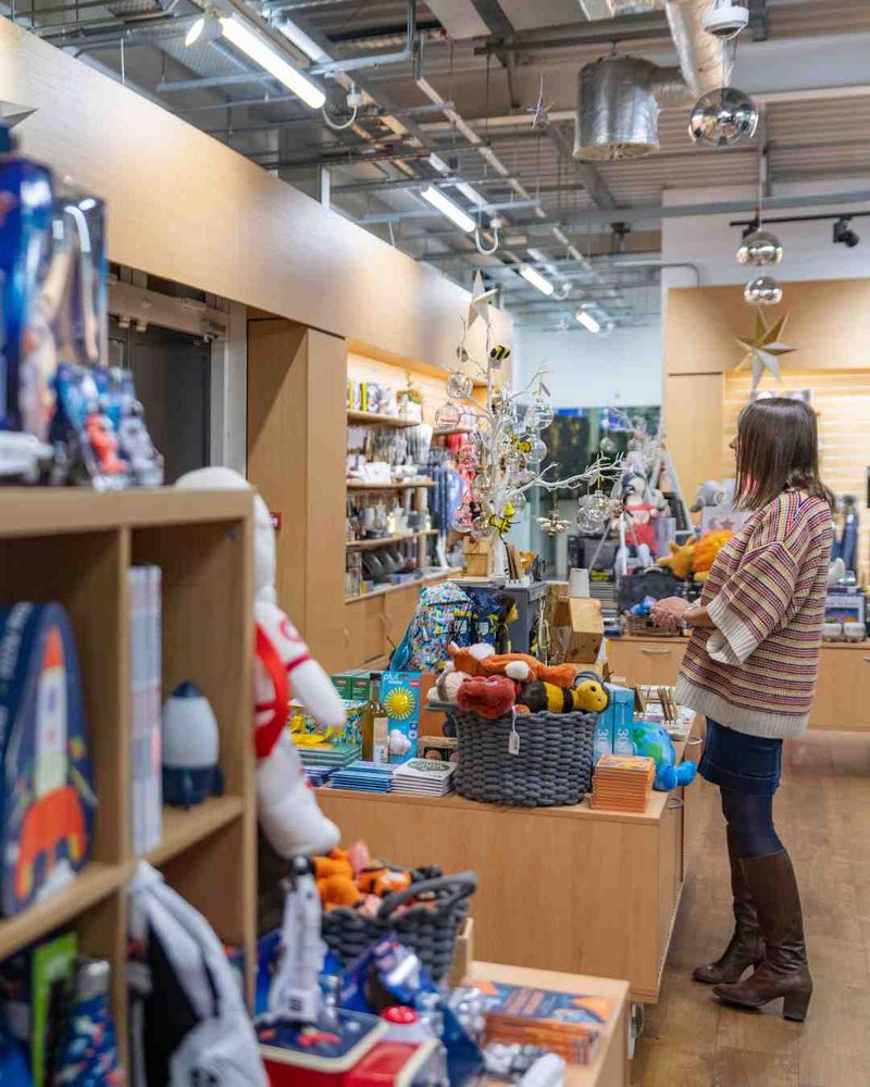 A photo of a woman browsing the shop, packed with colourful science-themed gifts.