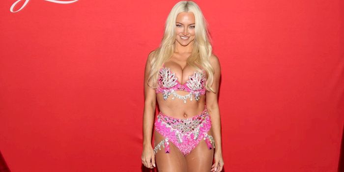 big boob blonde smiles while posing in pretty lingerie