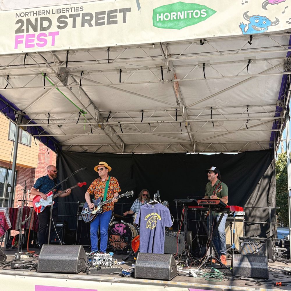 I Think Like Midnight, a band, playing on an outdoor stage