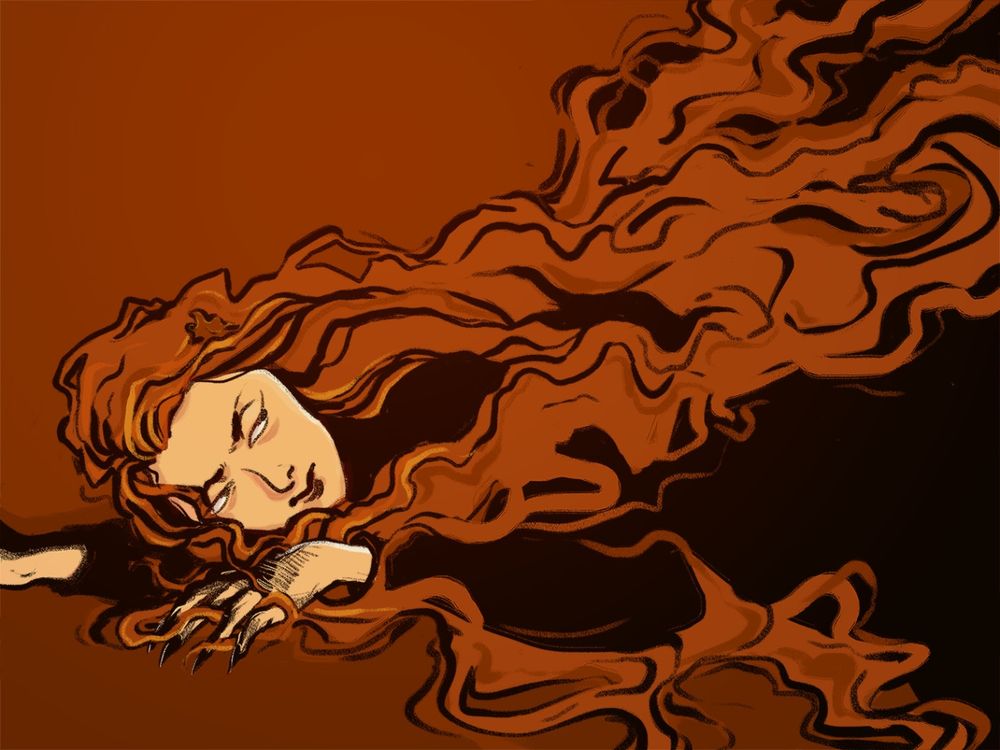 A woman with long orange hair and long black nails lying on the floor looking sinister.