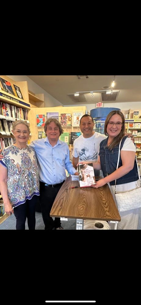 Two members of the audience receive an autographed copy of our book. 