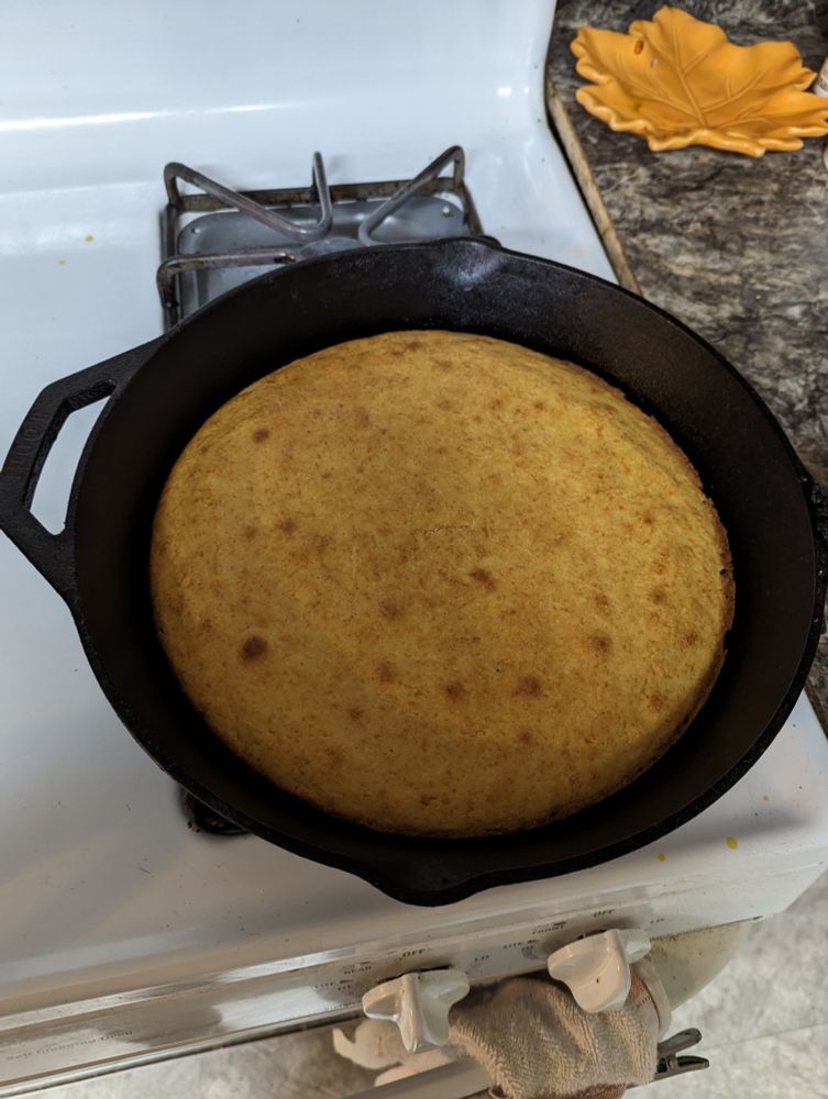 Some cornbread in a cast iron skillet.