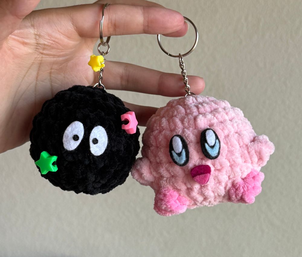 handmade crochet soot sprite and Kirby keychains