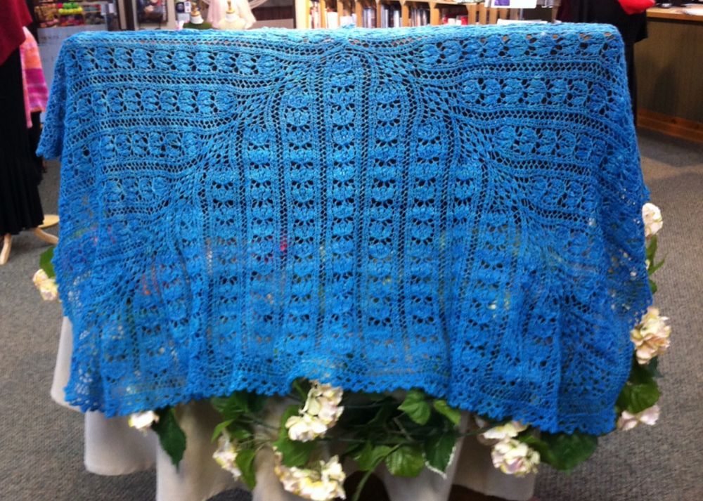 A blue lace rectangular shawl made of handspun merino/silk. 
