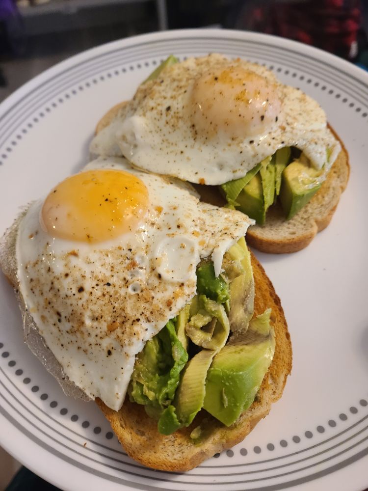 avocado toast with fried egg on rye