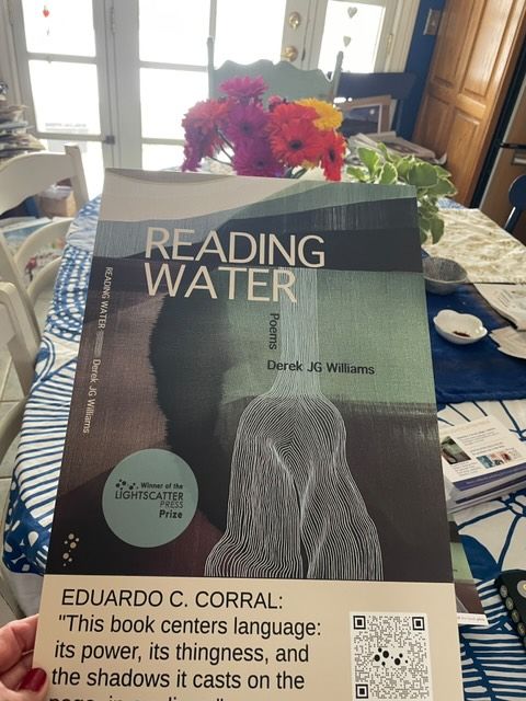 book promo materials from Reading Water with flowers in the background