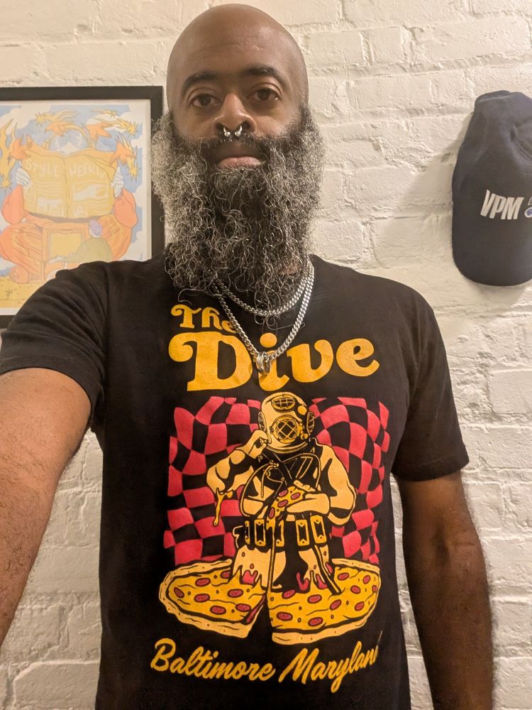 Elliott Robinson wearing a T-shirt for The Dive, at the intersection of Elliott & Robinson in Baltimore.