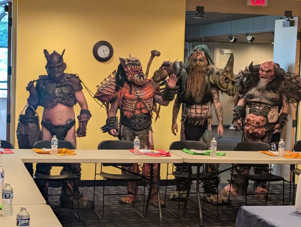 GWAR standing in a conference room.