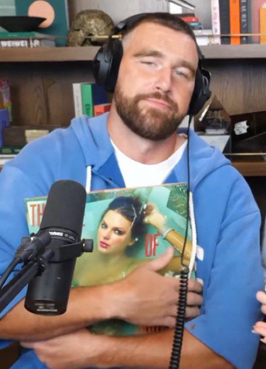Travis Kelce holding The Life of a Showgirl 