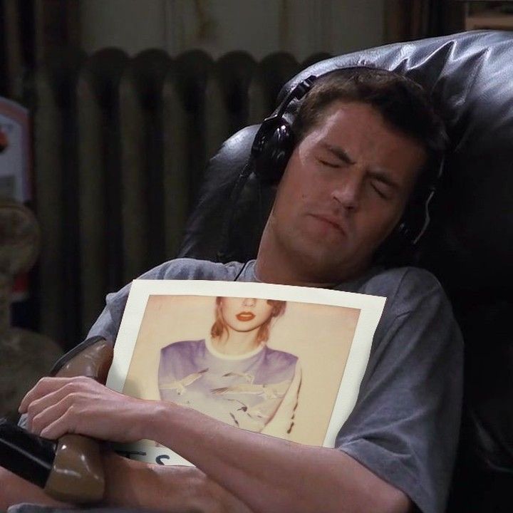 A photo of chandler from friends holding a taylor swifts 1989 album