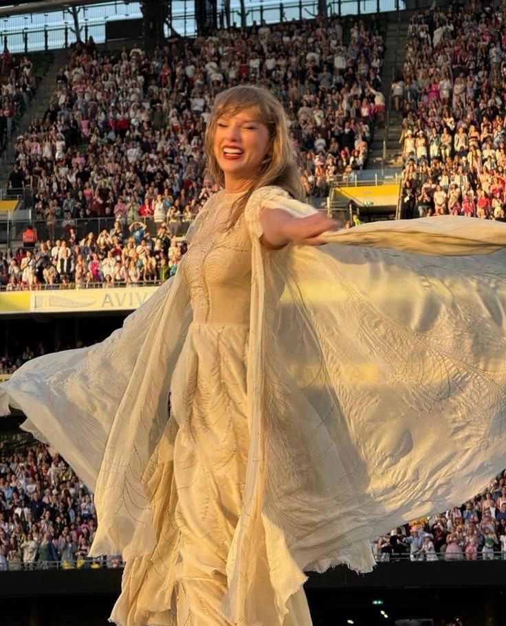 Taylor Swift wearing the cream folkmore dress on the eras tour 