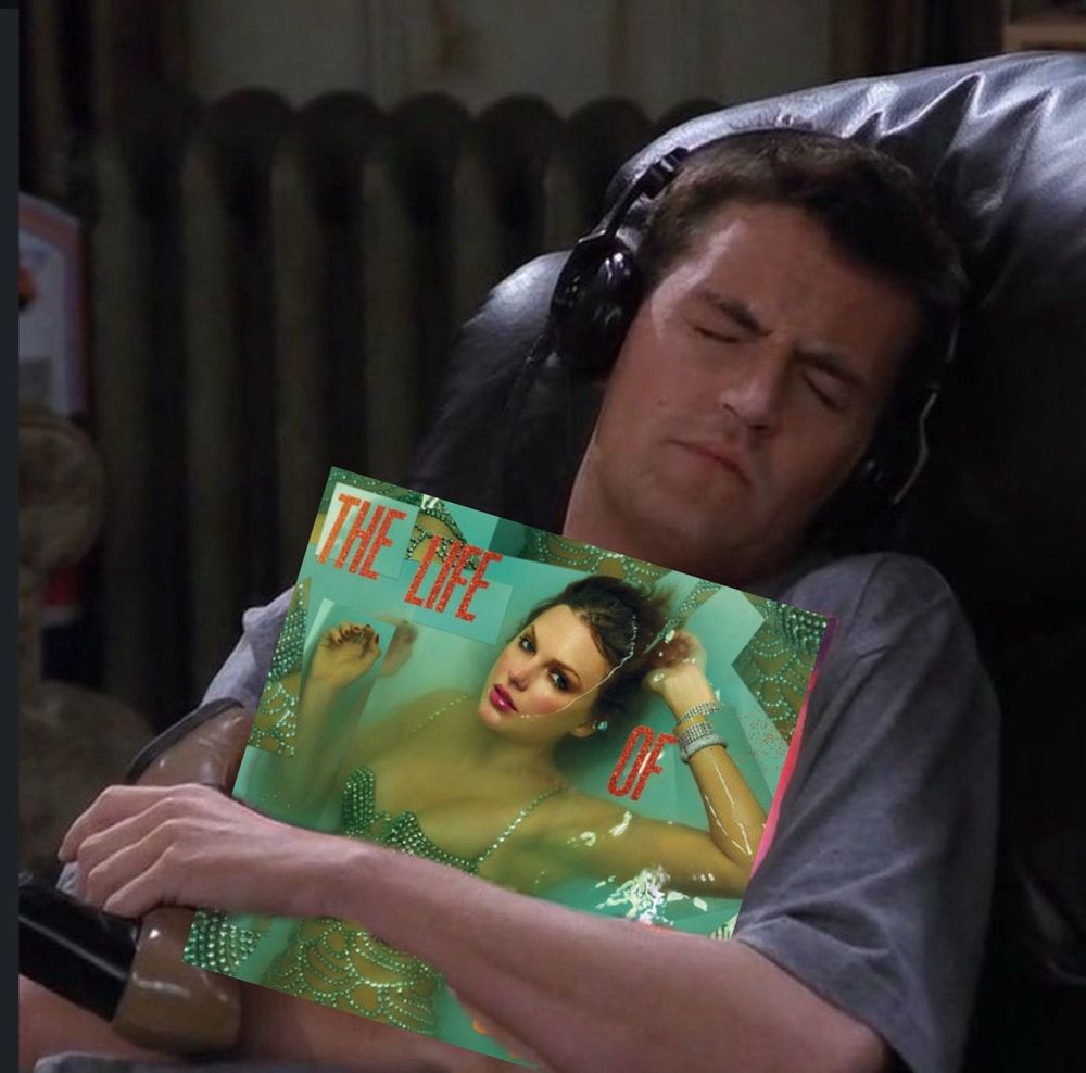 Chandler from Friends holding The Life of a Showgirl album