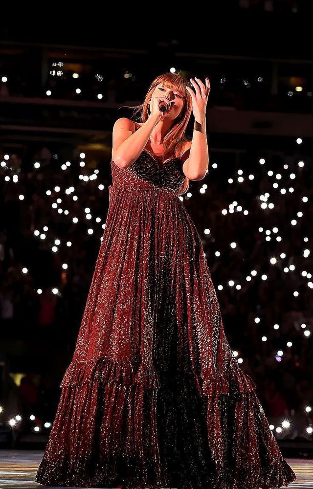 Taylor Swift singing wearing the bronze evermore dress 