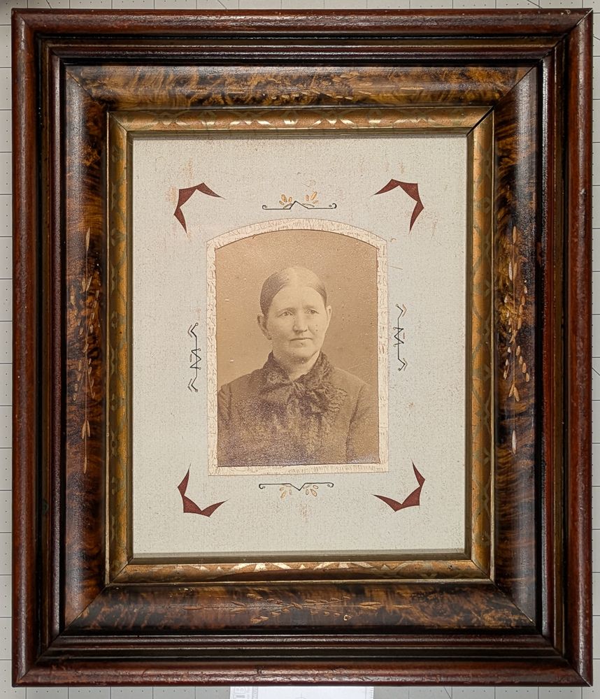 Photograph of a woman from about 1900 in a decorative Eastlake style frame