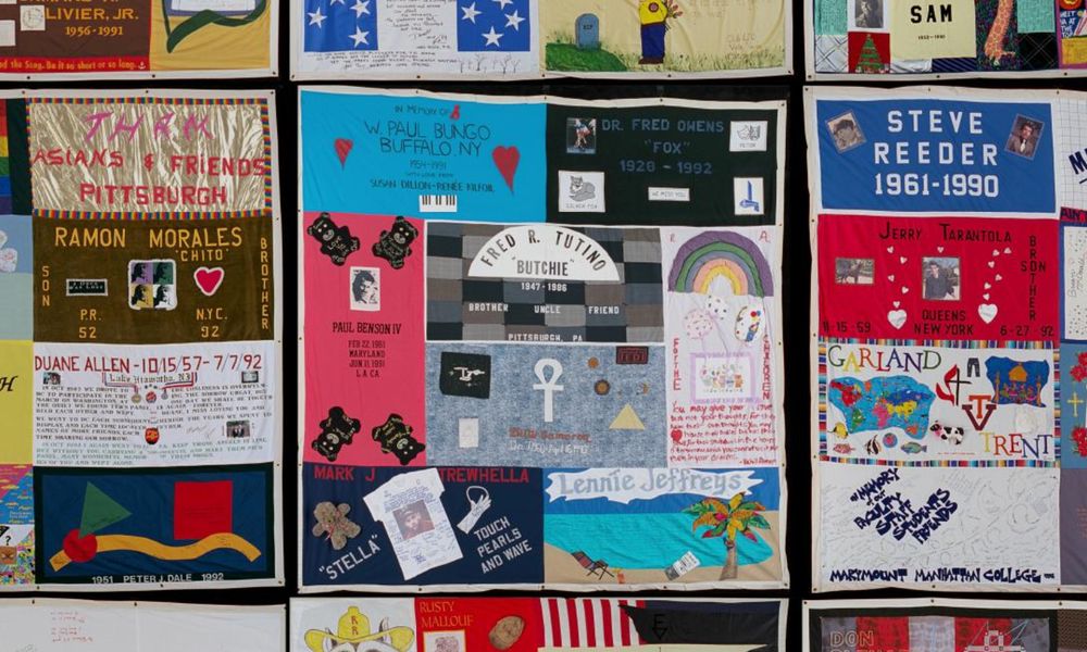 Panels from block #2926 of the AIDS Memorial Quilt. Some of the people's names are large and easy to read, while others are smaller. A block is consists of 8 different panels all the same size, but some are oriented horizontally and others vertically.