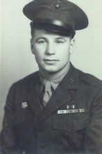 A black and white photo of a skinny 16 year old young man wearing a USMC uniform. 