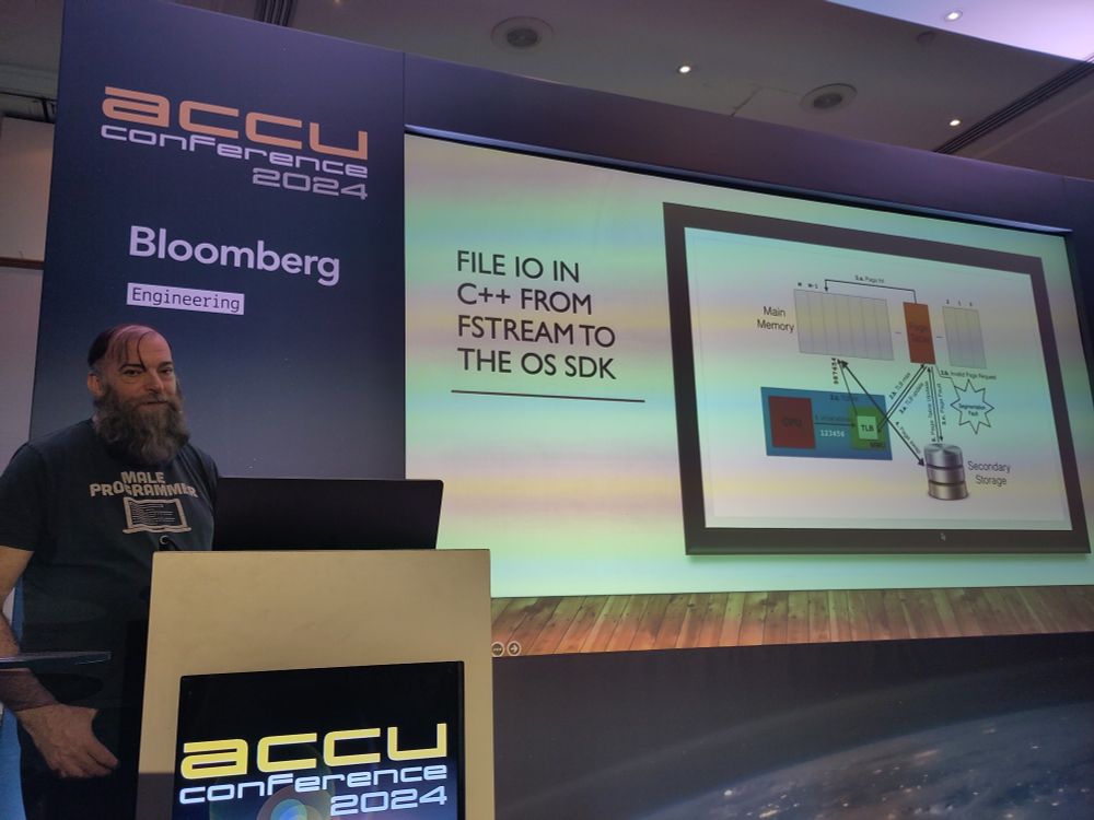 Guy in front of his slide of the way of data flow between CPU and disk.