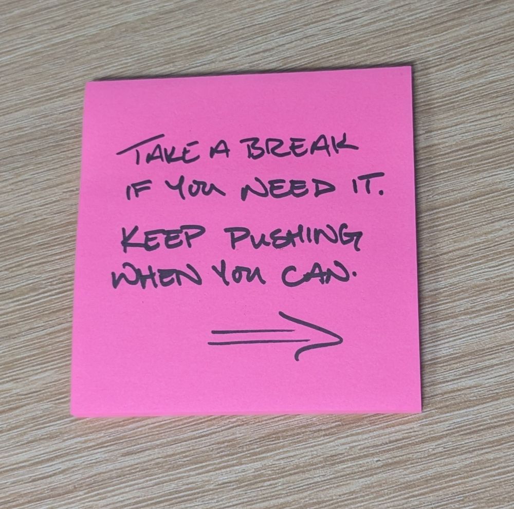 Pink stick note with a handwritten message:
Take a break if you need it.
Keep pushing when you can.