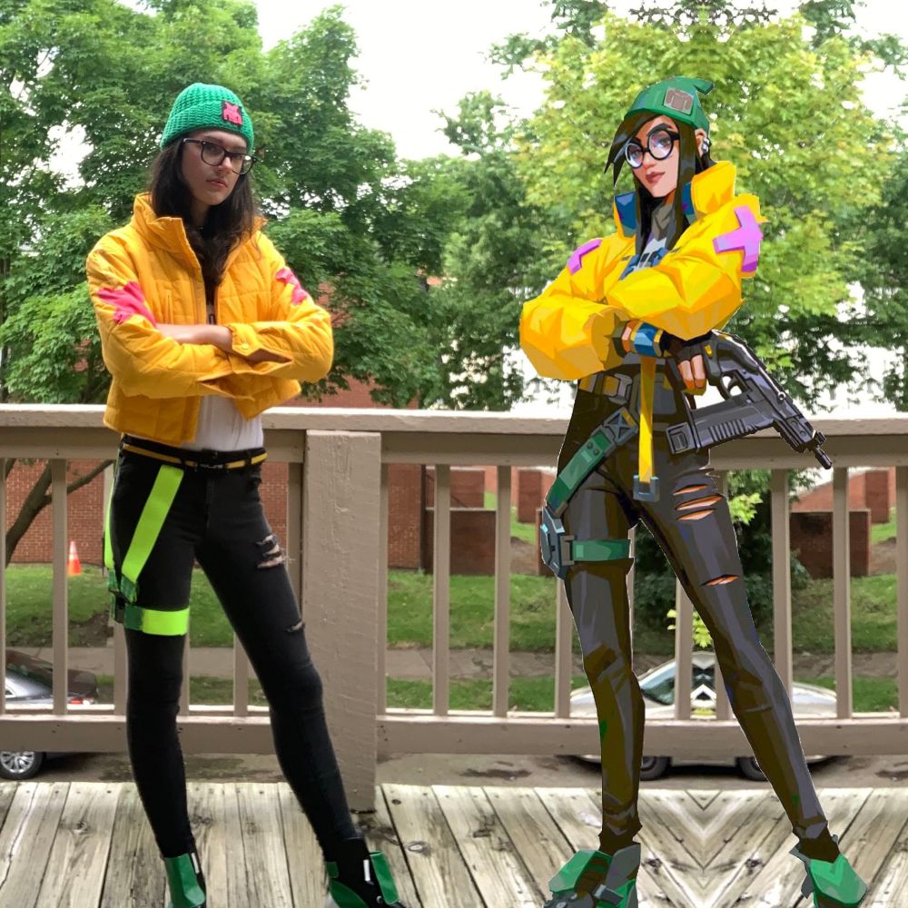 a side by side of KJ from valorant with a white woman cosplaying her. Yellow puffy coat, green hat, green boots, black jeans. Background is a wooden deck with trees behind overlooking a street.