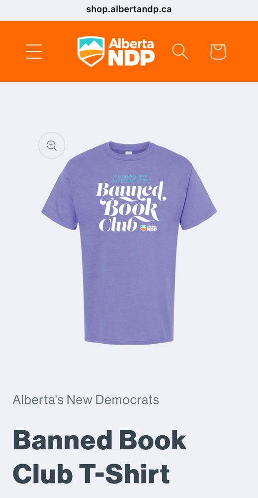 Purple shirt with swoosh script that says I’m gonna keep reading at the Banned Book Club 
Alberta NDP