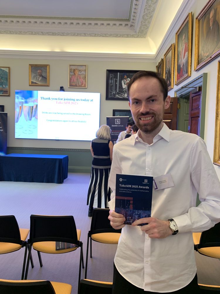 A photo of myself, posing with the awards booklet at the ceremony.