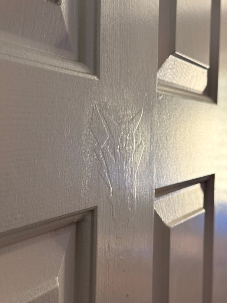 My office door angled toward the light which reveals the outline of pikachu, which was probably a sticker that the landlord painted over 
