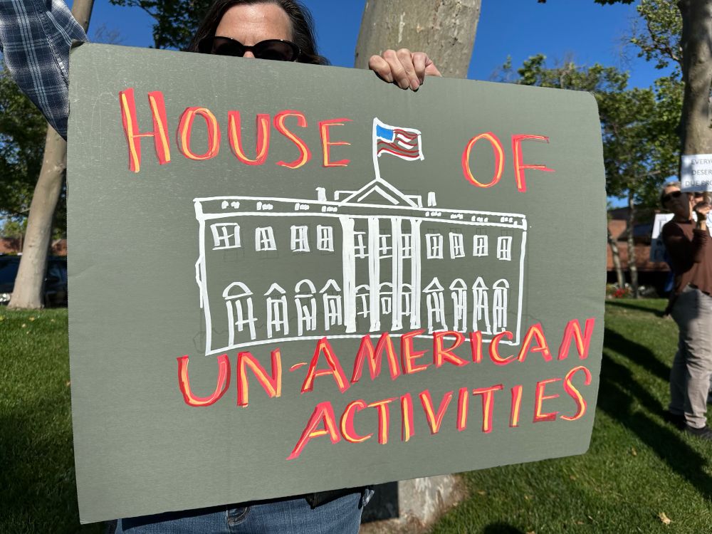 Sign which reads “House of Unamerican Activities” and features a drawing of the White House