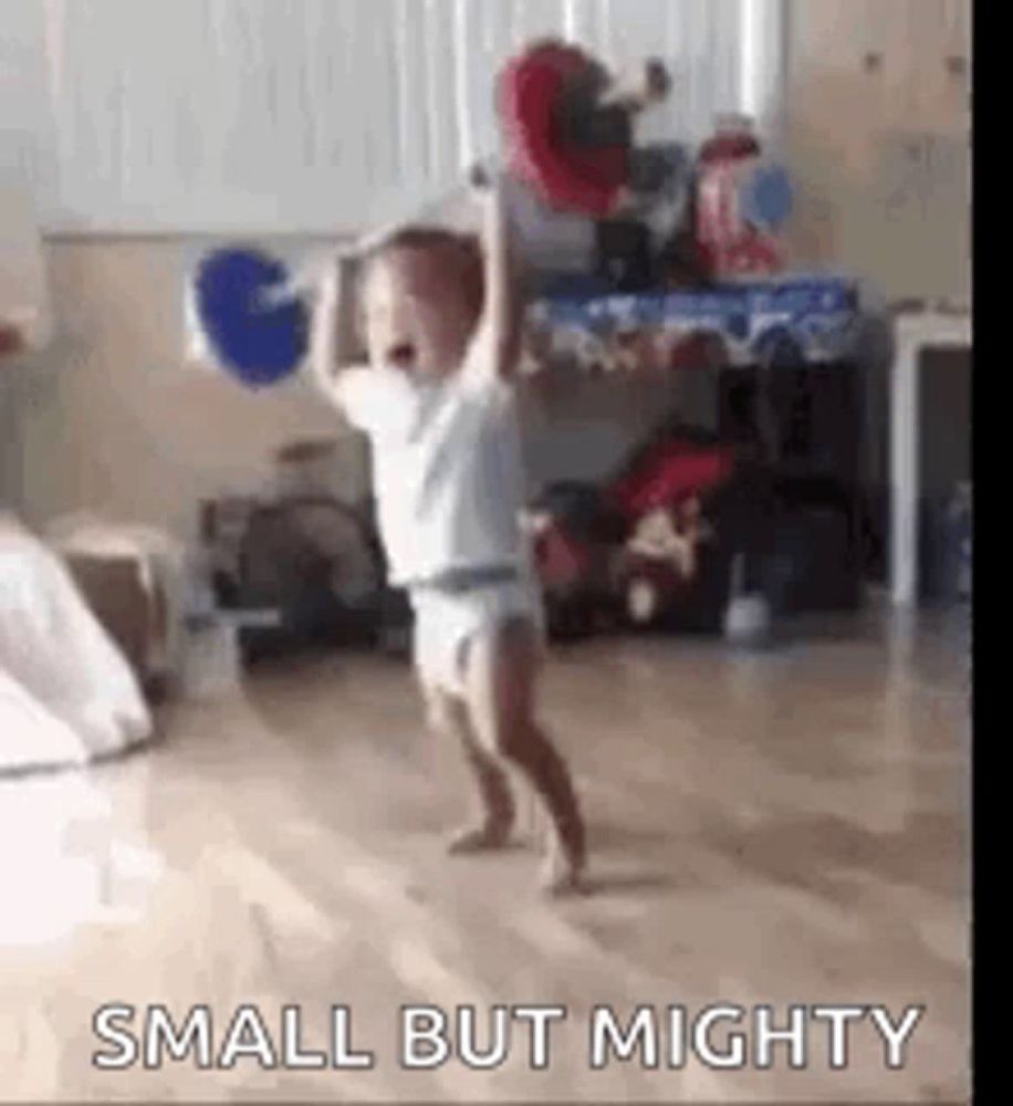 a baby in a diaper is dancing in a room .