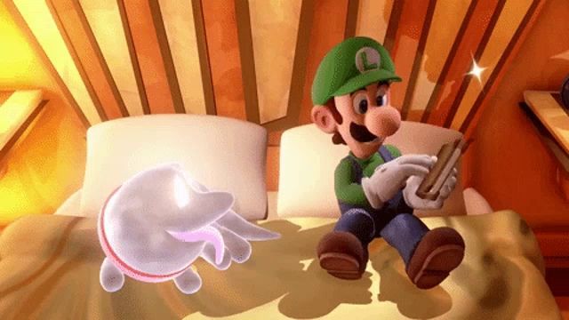 a video game character with the letter l on his hat sits on a bed