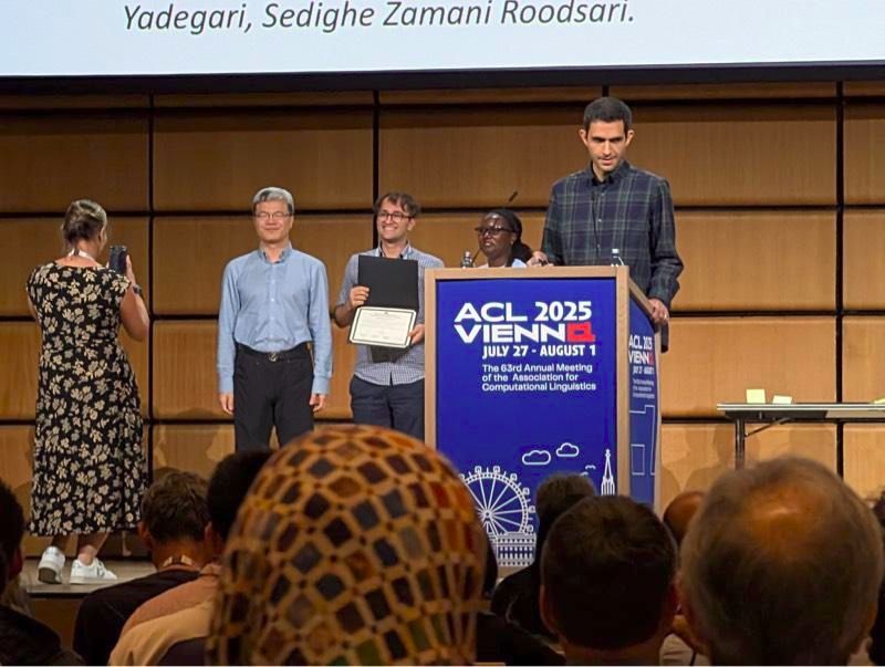 Sina Ahmadi receiving award.