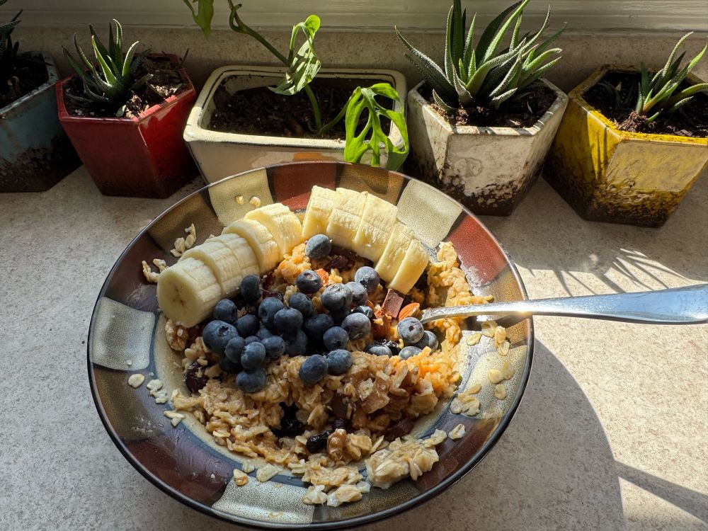 Oatmeal with bananas, blueberries, raisins, chocolate, walnuts, almonds, peanut butter, and maple syrup. 