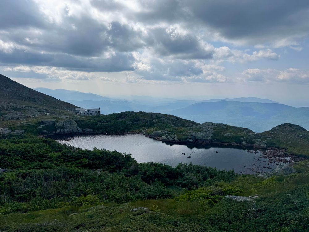 Lake of the Clouds hut with New Hampshire mountains in the background