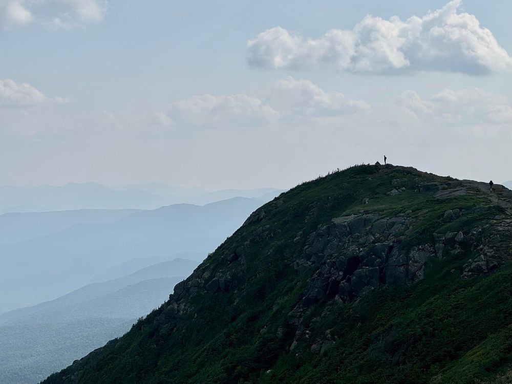 A solitary hiker atop Mt. Franklin admires the view