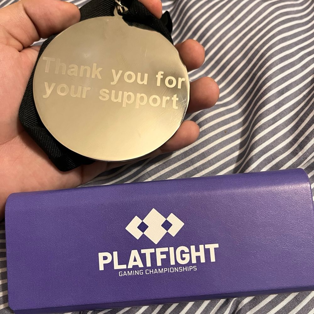 Platfight Finalist badge that says "Thank you for your support" on the back
Platfight Gaming Championships glasses case made by Zenni