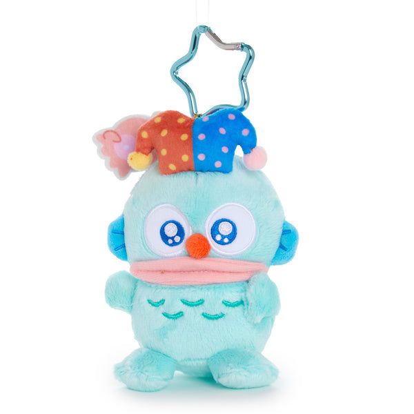 Sanrio plushie keychain of Hangyodon, a whimsical fish character. It’s dressed with blue and red jester hat and clown nose. 
