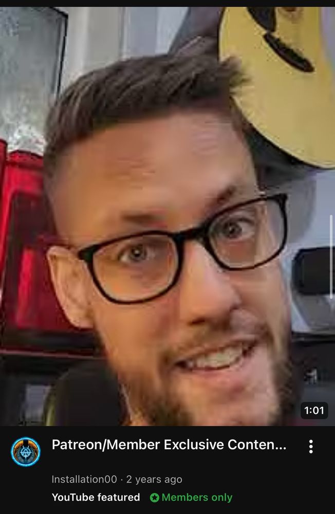 A YouTube advertisement for member exclusive content featuring a guys face. The guy is white, wearing black-framed glasses, and has a shitty beard.  