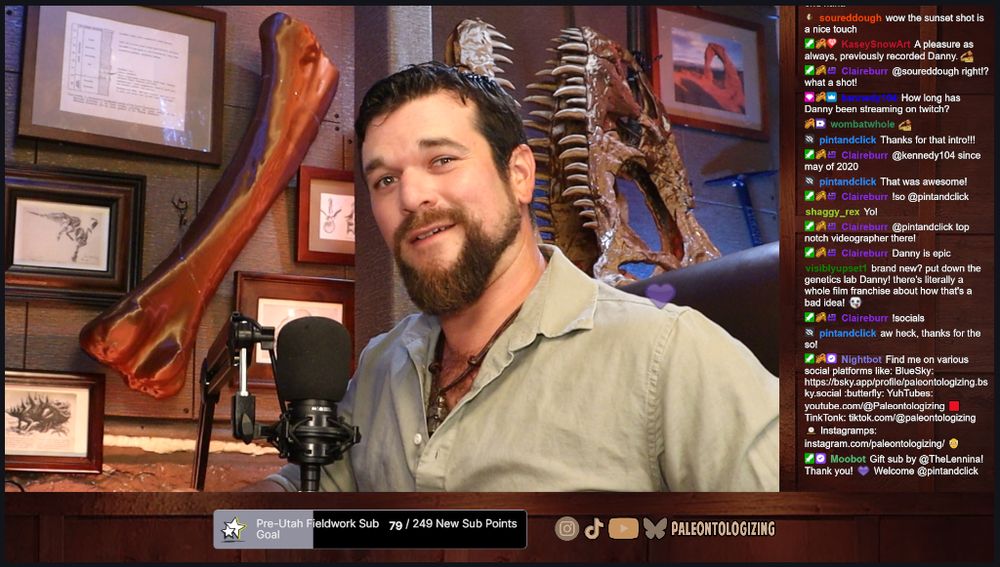 Twitch screenshot of me in my office, with 3D-printed Apatosaurus femur and Allosaurus skull in the background, along with various framed prints from scientific papers
