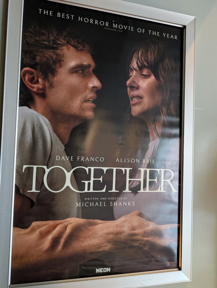 Poster for the movie together. A couple just huggin'.
