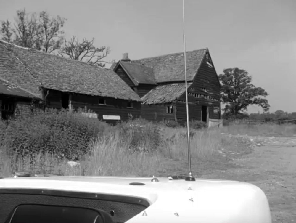 a black and white photo of a house with the letter a on the side