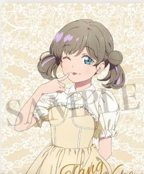 Keke Tang in a beige dress and her hair in buns and pigtails, winking and sticking her tongue out and pointing at her mouth