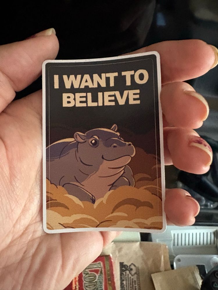 A sticker with the North American House Hippo reading "I want to believe"