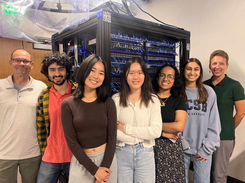 2 faculty and 5 researchers standing in front of raspberry pi computer cluster